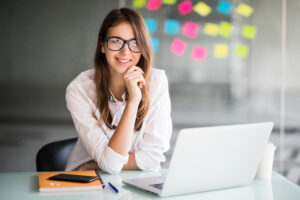 Woman smiling working at laptop